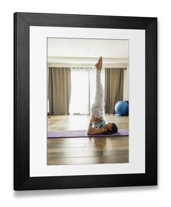 Framed Print : Side view of a woman practicing yoga Framed Print : Side view of a woman practicing yoga