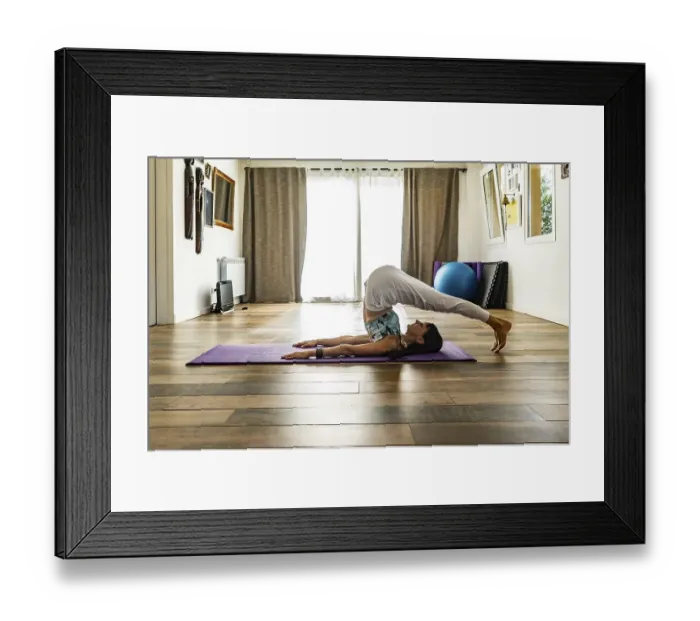 Framed Print : Side view of a woman practicing yoga Framed Print : Side view of a woman practicing yoga