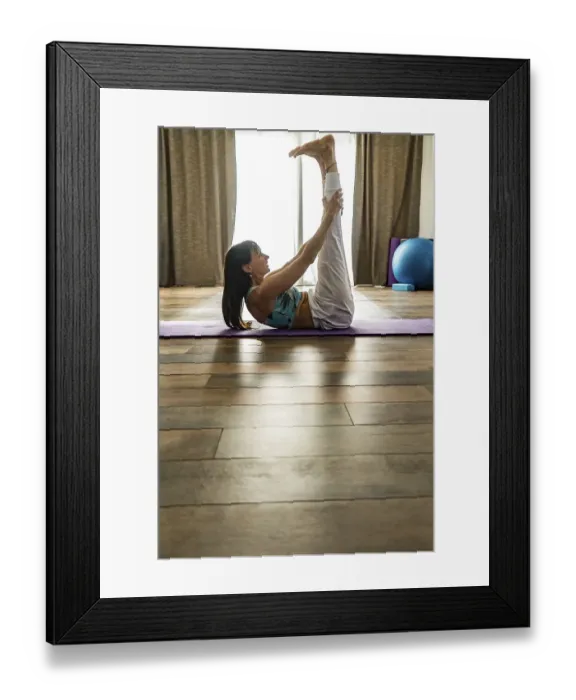 Framed Print : Side view of a woman practicing yoga Framed Print : Side view of a woman practicing yoga