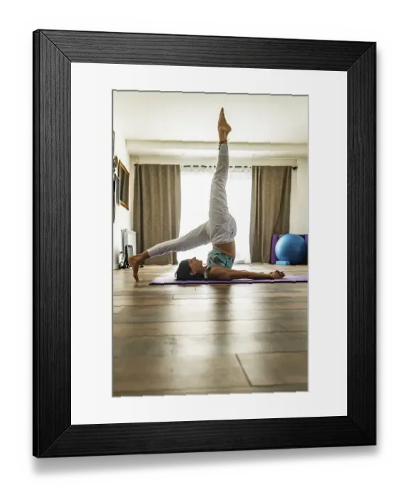 Framed Print : Side view of a woman practicing yoga Framed Print : Side view of a woman practicing yoga