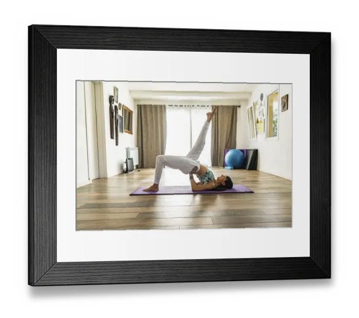 Framed Print : Side view of a woman practicing yoga