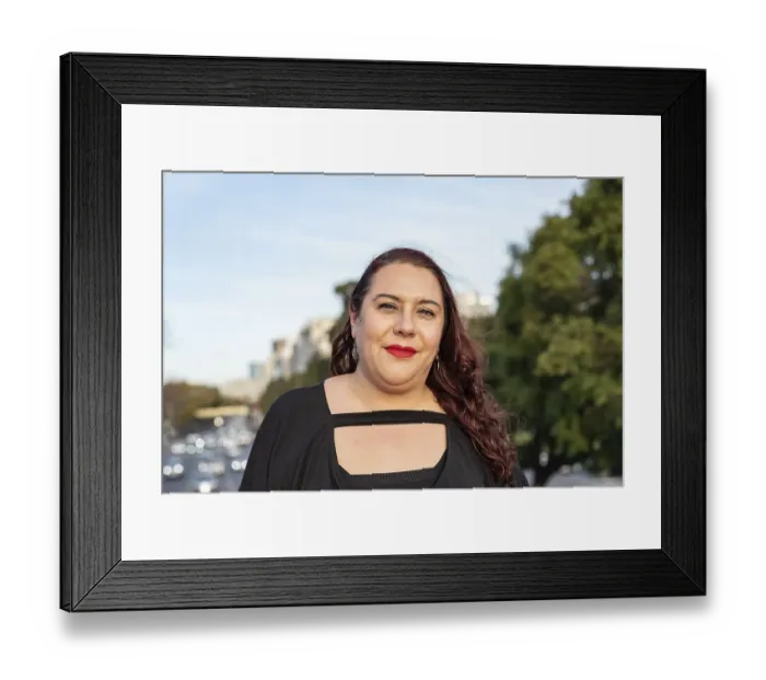 Framed Print : Portrait of a smiling plus-size woman looking at camera