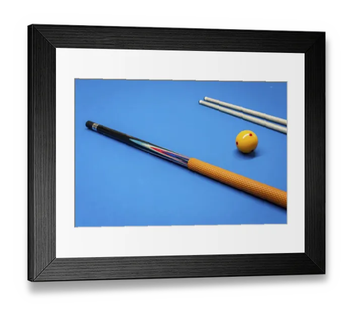 Framed Print : Cue sticks and a yellow ball on a billiard table