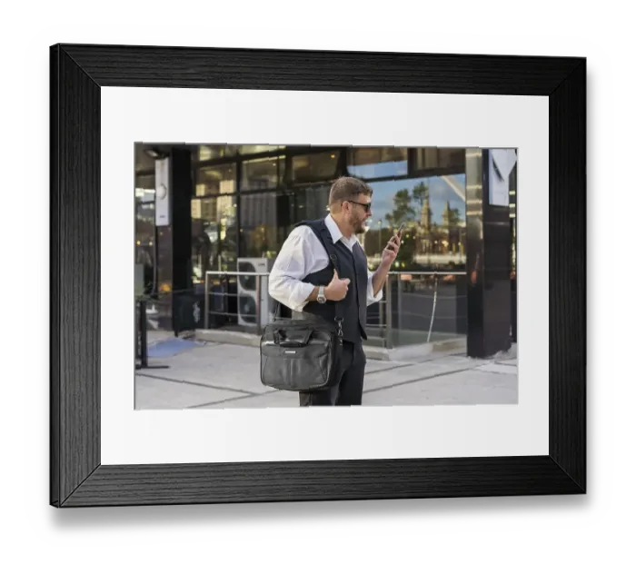 Framed Print : A businessman leaving a message to his friend before entering an after-office