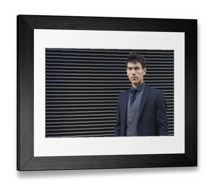 Framed Print : Front view of an attractive executive man wearing a suit while looking at camera Framed Print : Front view of an attractive executive man wearing a suit while looking at camera
