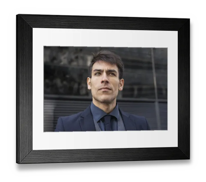 Framed Print : Low-angle view of an attractive executive man looking away Framed Print : Low-angle view of an attractive executive man looking away