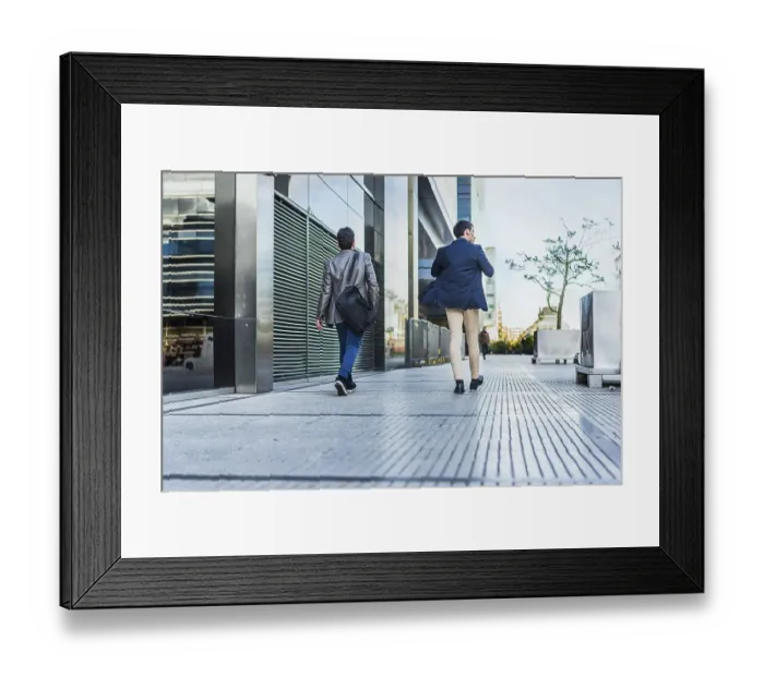 Framed Print : Rear view of two colleagues going to a meeting while they are walking on the street Framed Print : Rear view of two colleagues going to a meeting while they are walking on the street
