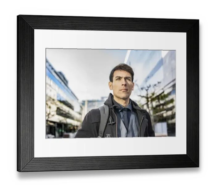 Framed Print : Low-angle view of an attractive businessman with his backpack on looking away while walking from his office