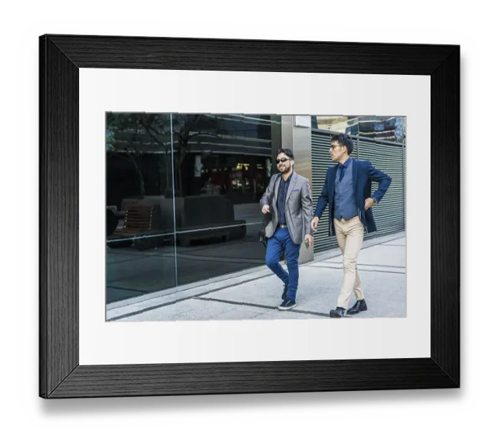 Framed Print : Two business colleagues are talking while walking on the street Framed Print : Two business colleagues are talking while walking on the street