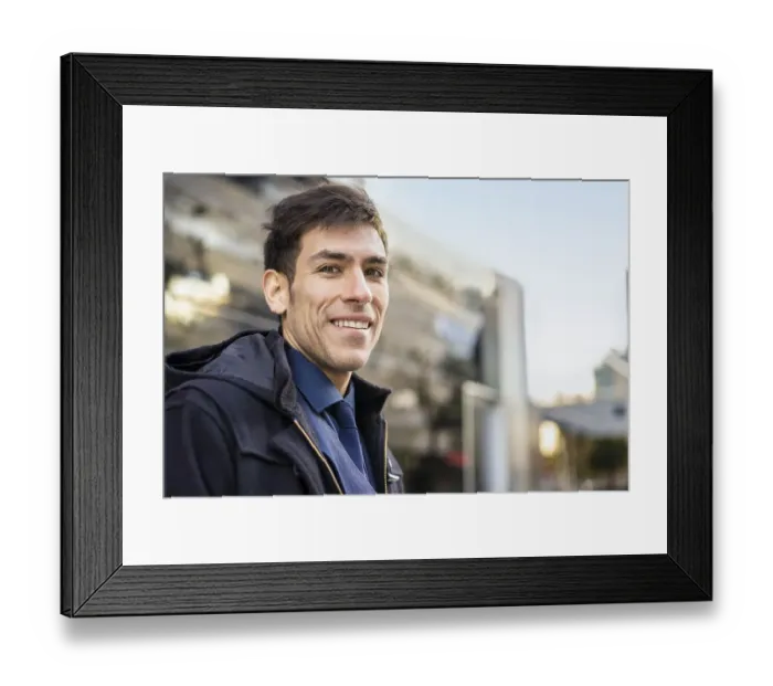 Framed Print : Low-angle view of an attractive man looking at camera