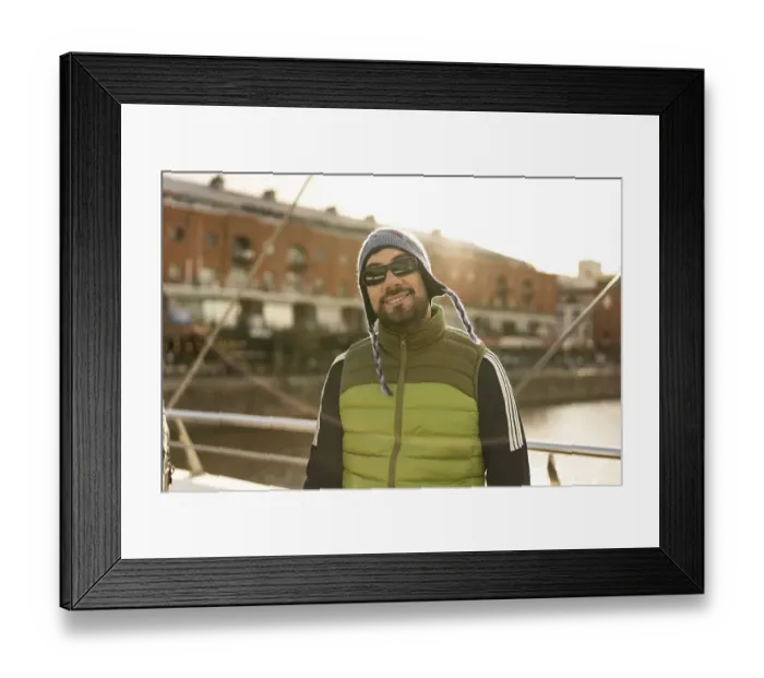 Framed Print : Portrait of a good looking latin man tourist looking at camera in Puerto Madero