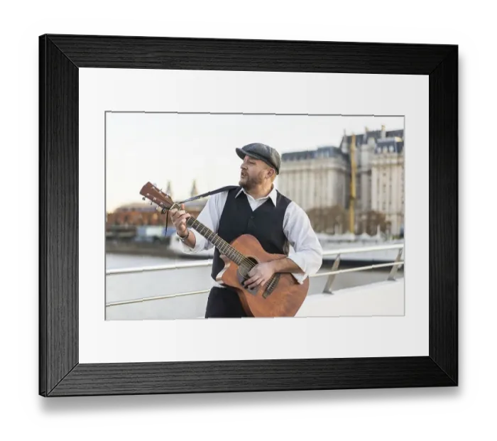Framed Print : A street musician performing classic songs while playing guitar