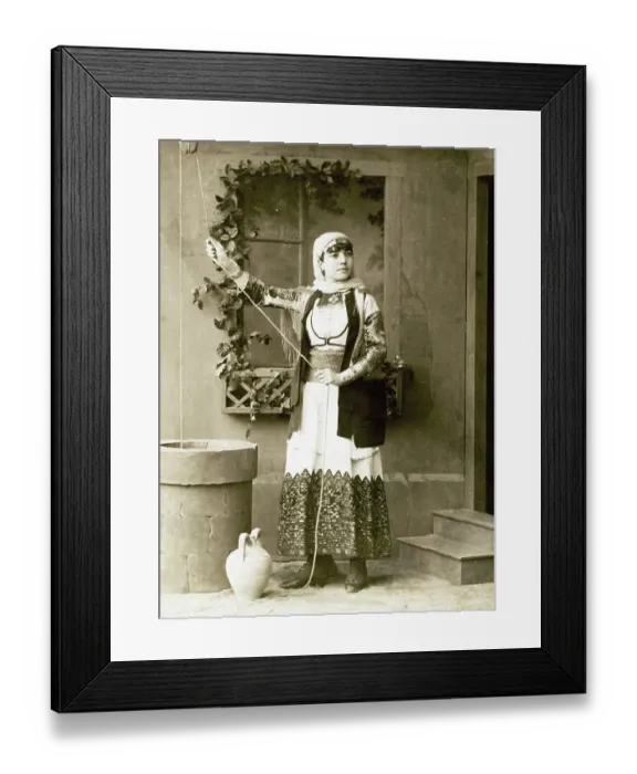 Framed Print : Studio portrait of a woman in traditional Greek dress beside a fountain Framed Print : Studio portrait of a woman in traditional Greek dress beside a fountain