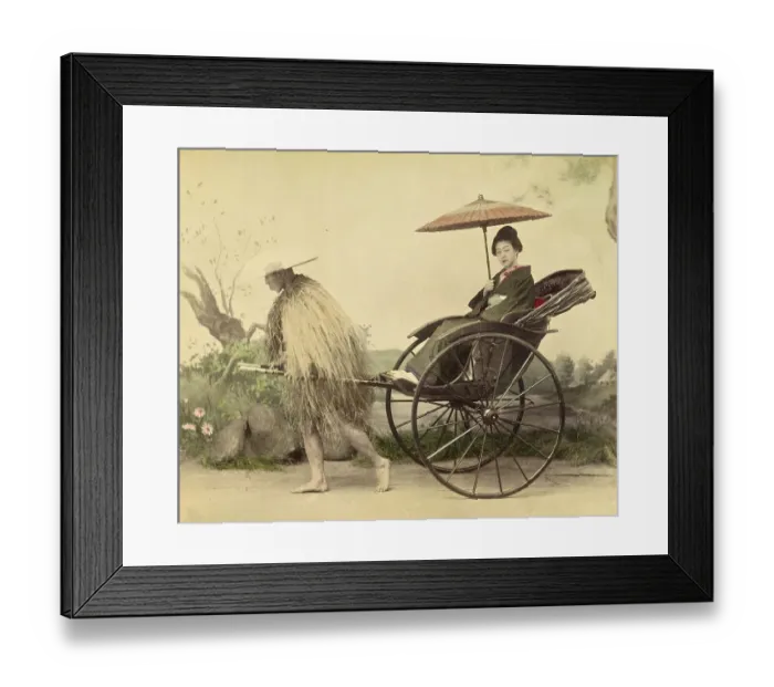 Framed Print : A distinguished woman with a parasol being pulled in a jinrikisha by a man wearing a straw mackintosh