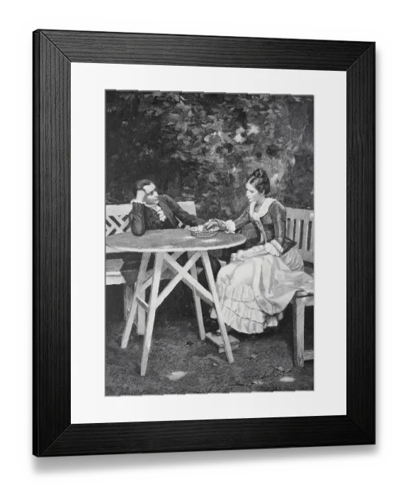Framed Print : A couple sitting at a table in the garden having a conversation
