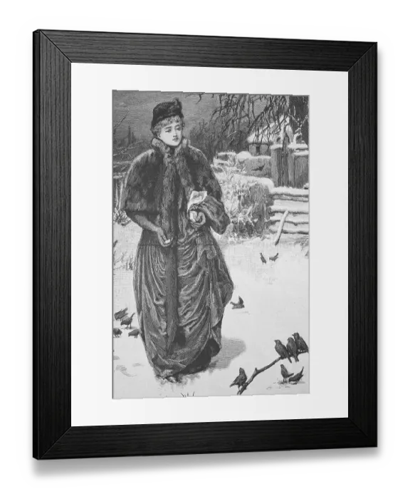 Framed Print : Woman feeding the wild birds in the park in winter