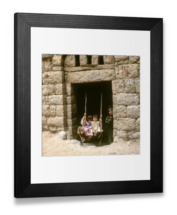 Framed Print : Children rocking in a house entrance, Amran, Yemen, Asia