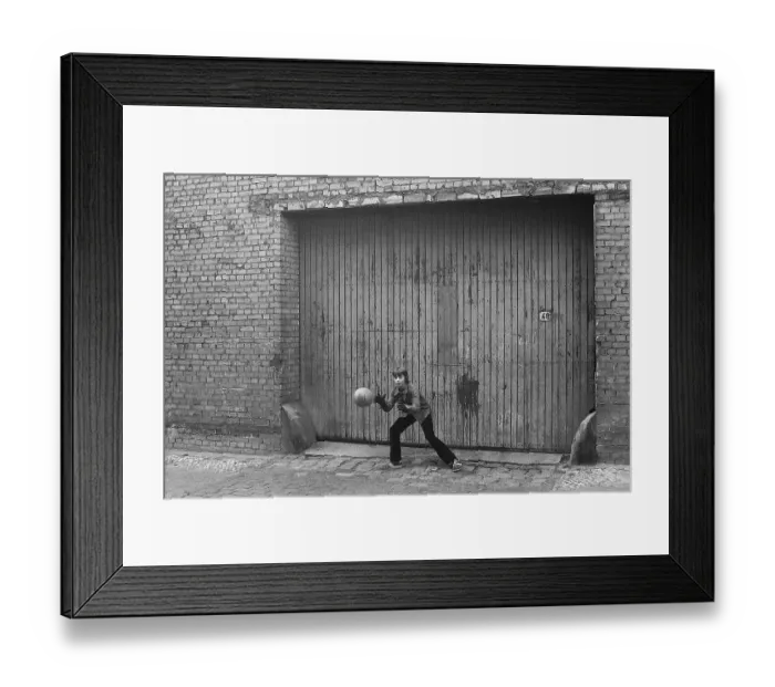 Framed Print : 07.12.1981, East Berlin, district Prenzlauer Berg, Kopenhagener Strasse, young goalkeeper catches the ball in a gateway East Berlin, Berlin-Prenzlauer Berg, GDR GDR