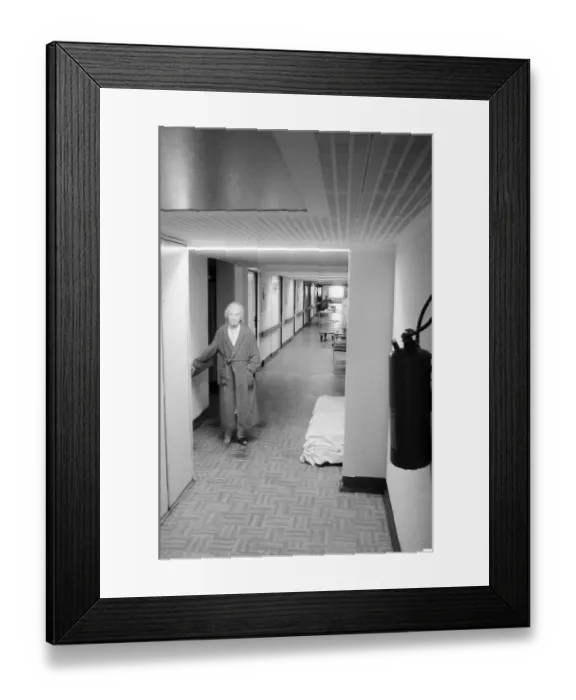 Framed Print : 03.04.1982, East Berlin, Biesdorf district, old people's and nursing home, nursing ward, a woman in a bathrobe stands on the ward corridor, Biesdorf, Marzahn-Hellersdorf, GDR