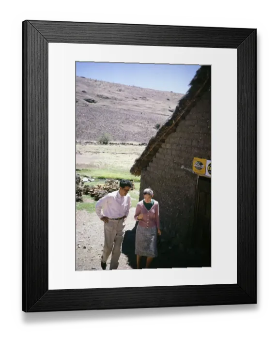 Framed Print : British tourist and man in rural area near Ayacucho, Peru, South America 1962, walking past an adobe building, South America