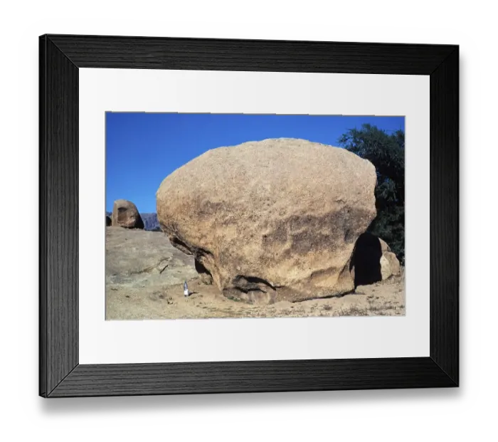Framed Print : Wind erosion and weathering of a large granite block in a desert area in Morocco, North Africa Framed Print : Wind erosion and weathering of a large granite block in a desert area in Morocco, North Africa