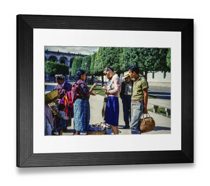 Framed Print : Tourist buying a souvenir from a local Mayan street vendor Antigua, Guatemala, Central America around 1961, Central America