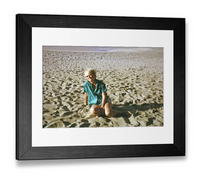 Framed Print : Expatriate tourist woman sitting on sandy beach, island of Tobago, 1963