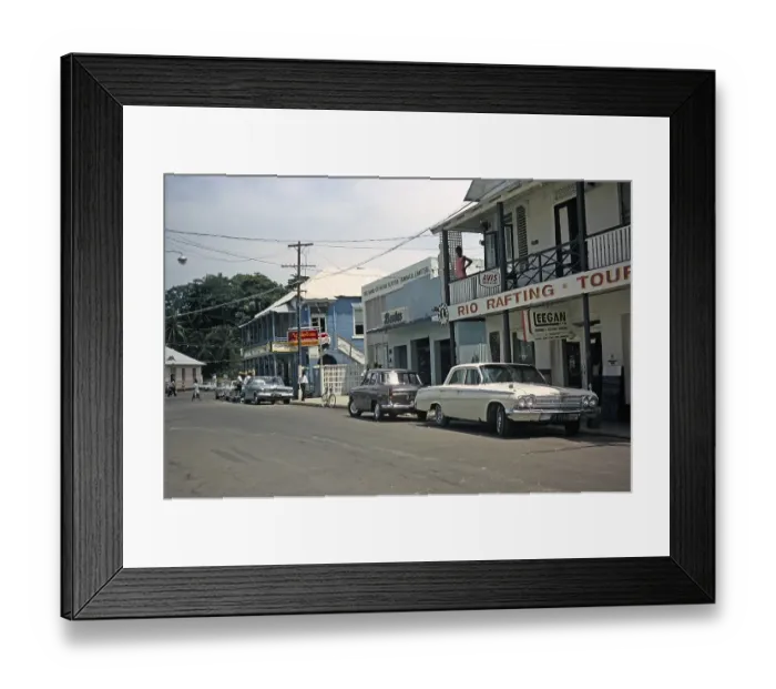 Framed Print : Street scene shops, bank, bar, tourists and vintage car, probably Port Antonio, Jamaica 1970 Framed Print : Street scene shops, bank, bar, tourists and vintage car, probably Port Antonio, Jamaica 1970