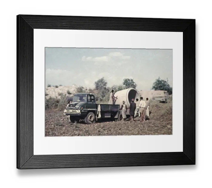 Framed Print : Unloading a large section of drainage pipe from a lorry for use in an irrigation project in rural Pakistan 1962