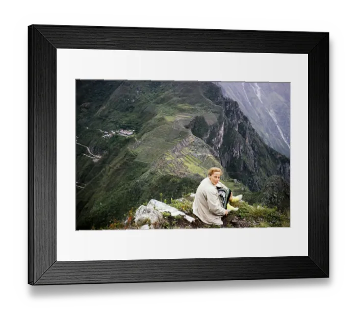 Framed Print : Female tourist sitting on the mountain Huayna Picchu with view of Machu Picchu, Peru, South America around 1962 note the footwear!, South America