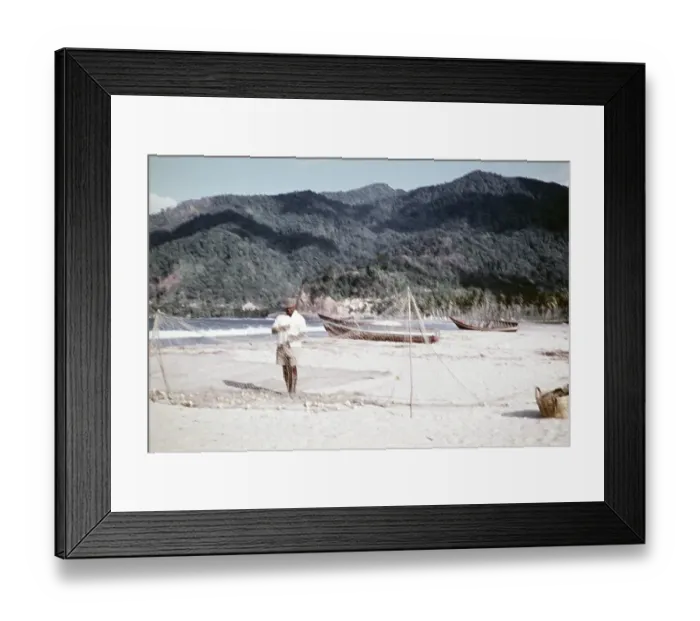 Framed Print : Out of focus, fishermen repairing nets and fishing boats on the sandy beach of Maracas, Trinidad around 1962