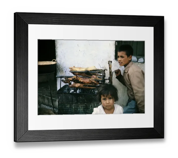 Framed Print : Children roasting guinea pigs on a spit at the market in Ambato, Ecuador, South America, 1962, South America