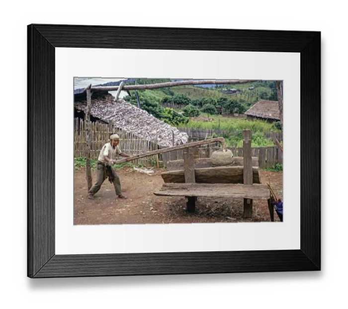 Framed Print : Man with an old grain pestle in a rural village, Northern Thailand, Asia 1971 Framed Print : Man with an old grain pestle in a rural village, Northern Thailand, Asia 1971