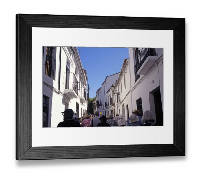 Framed Print : A group on a guided tour through the narrow streets of Ronda, Spain, Europe Framed Print : A group on a guided tour through the narrow streets of Ronda, Spain, Europe
