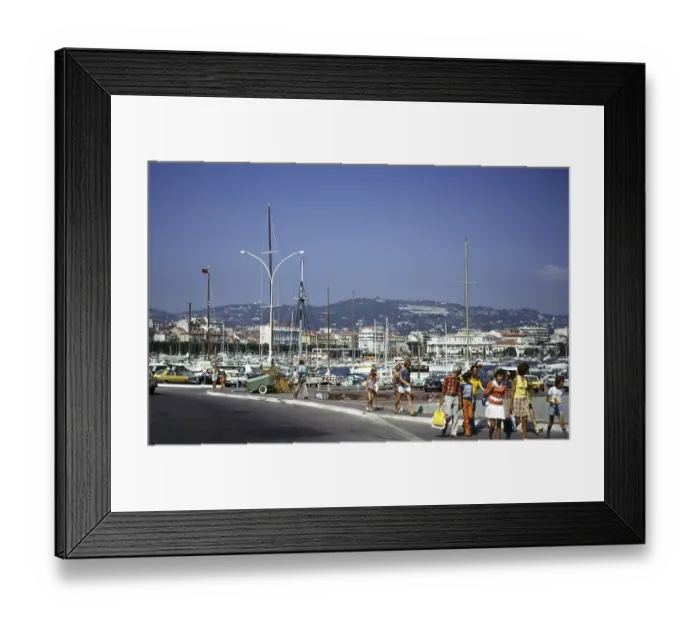 Framed Print : People walking past a harbour crowded with boats in Cannes, Cote d'Azur, France 1974