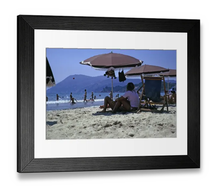 Framed Print : Sandy beach, children playing in the sea and people sitting under parasols, Les Sablettes, French Riviera, France 1974