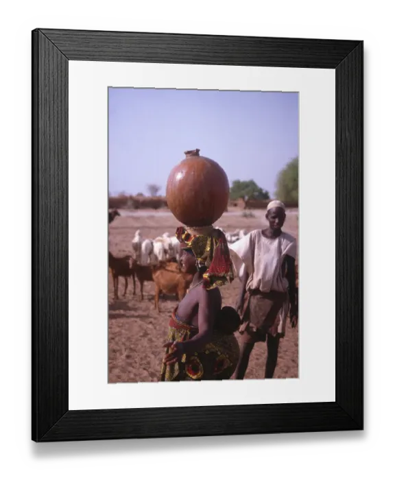 Framed Print : Life in the Sahel region of northern Nigeria, west Africa, early 1980s - woman carrying water