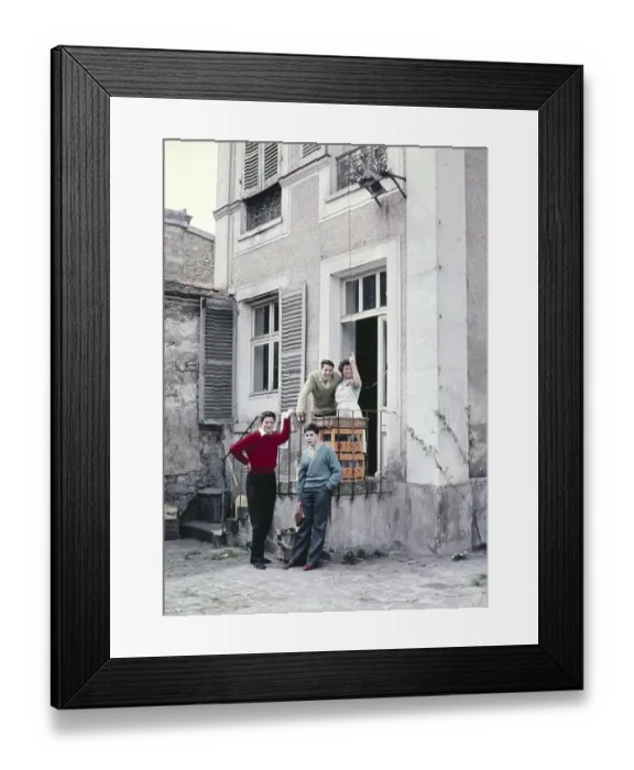 Framed Print : Young French woman making arm gesture with three English schoolboy students at back of cafe, France c 1960