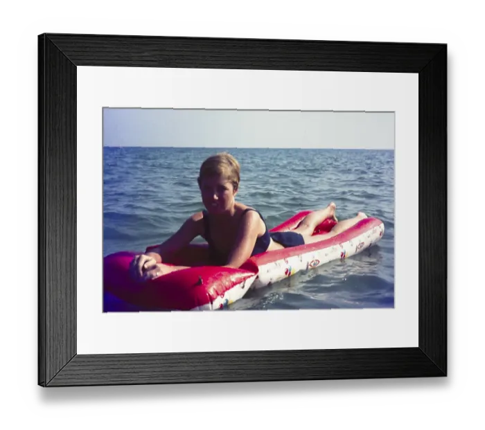 Framed Print : Young British woman on holiday floating in sea of inflated lilo, Spain, 1966, Europe