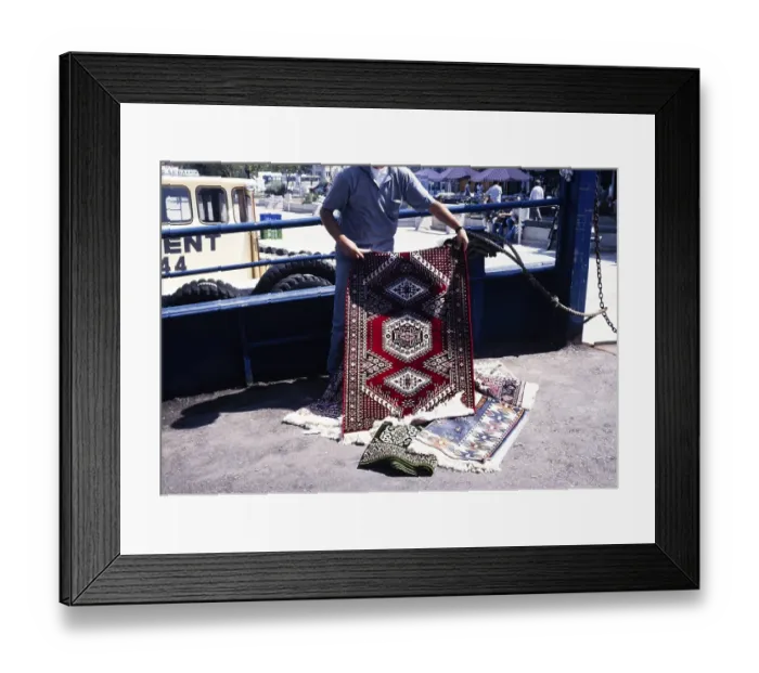 Framed Print : Street vendor offering a Turkish carpet for sale in Cannakale, Turkey (1997)