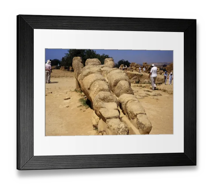 Framed Print : Tourists visiting the Greek ruins of the giant statue of Atlas or Telamon, Temple of Zeus, Akragas, Agrigento, Sicily, Italy 1999