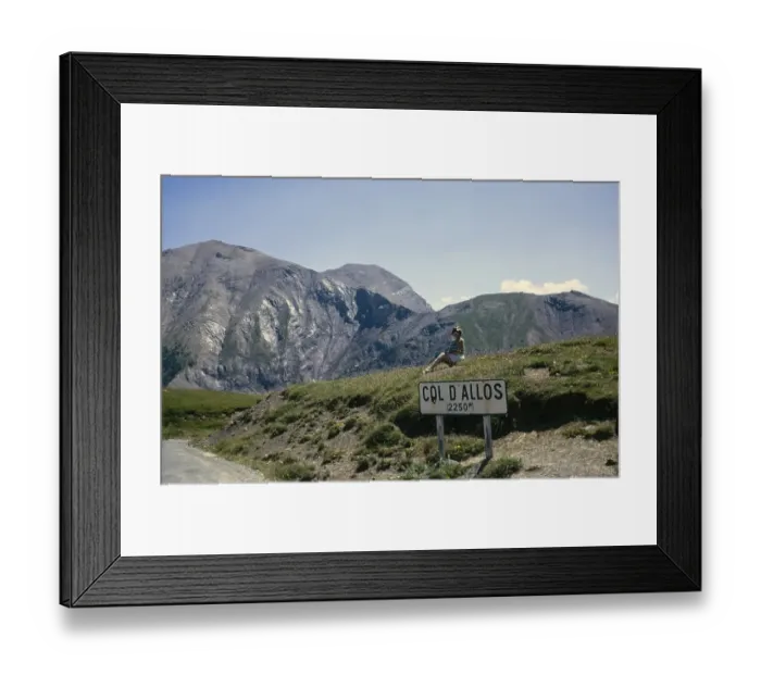 Framed Print : Woman sitting at sign for Col d'Allos 2250m Alpine pass, Alpes-de-Haute-Provence, France 1974 Framed Print : Woman sitting at sign for Col d'Allos 2250m Alpine pass, Alpes-de-Haute-Provence, France 1974