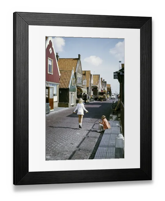 Framed Print : Volendam, Netherlands, 1973: two children playing in the street, one of them jumping
