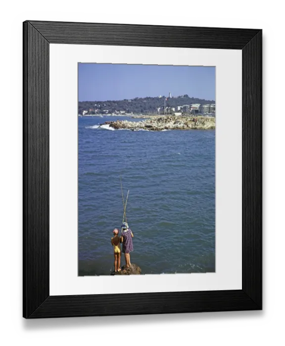 Framed Print : Two girls with fishing rods on a rock by the sea in Antibes, Cote d'Azur, France 1974