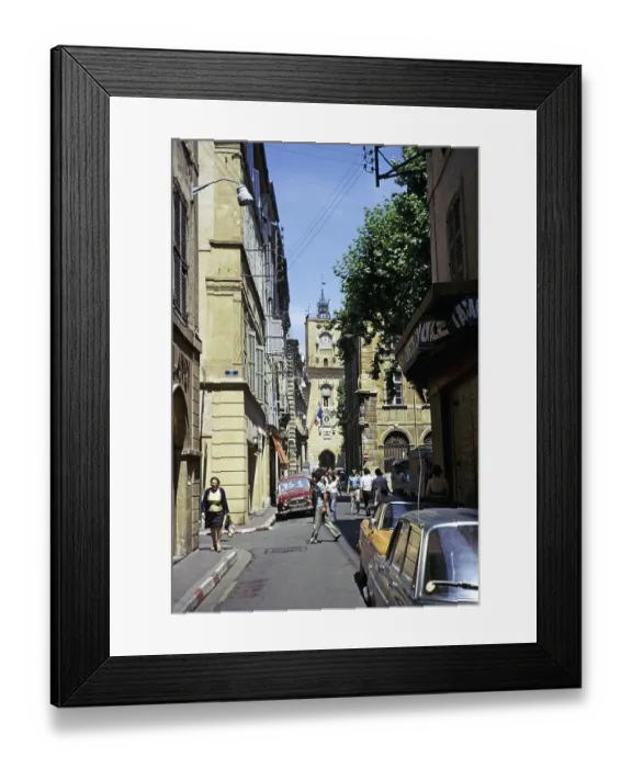 Framed Print : Historic buildings on the street in the city centre of Aix en Provence, France 1974 with the tower of the town hall in front of it Framed Print : Historic buildings on the street in the city centre of Aix en Provence, France 1974 with the tower of the town hall in front of it