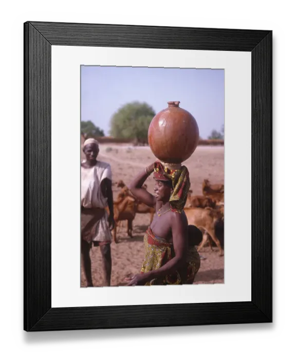 Framed Print : Life in the Sahel region of northern Nigeria, west Africa, early 1980s - woman carrying water