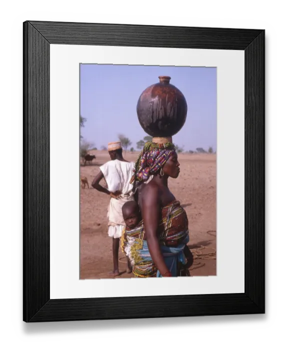 Framed Print : Life in the Sahel region of northern Nigeria, west Africa, early 1980s - woman carrying water