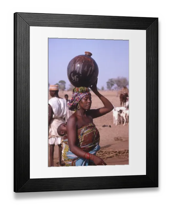 Framed Print : Life in the Sahel region of northern Nigeria, west Africa, early 1980s - woman carrying water Framed Print : Life in the Sahel region of northern Nigeria, west Africa, early 1980s - woman carrying water