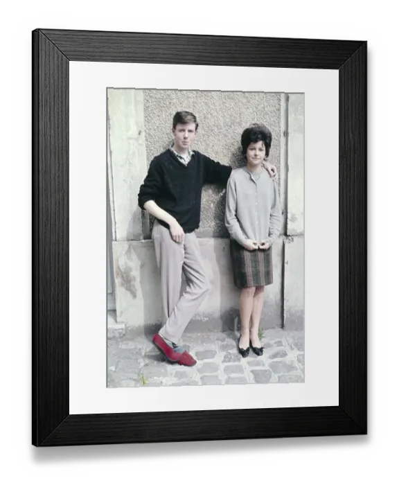 Framed Print : Young man casual smart clothing red slippers with his arm around shoulder of slim pretty young woman against wall of building, France c 1960 Framed Print : Young man casual smart clothing red slippers with his arm around shoulder of slim pretty young woman against wall of building, France c 1960
