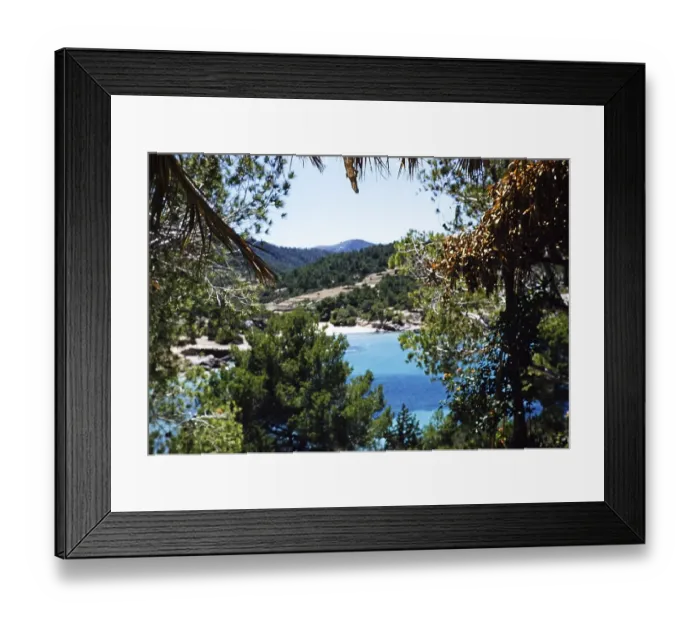 Framed Print : Coastal landscape view through trees of blue sea sandy beach, island of Ibiza, Balearic Islands, Spain, 1950s, Europe